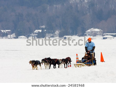 LAKE GEORGE, NY - February 7, 2009: Kids having a fun ride in a dog sled on the ice of Lake George during the February 7 , 2009 Lake George Winter Carnival.