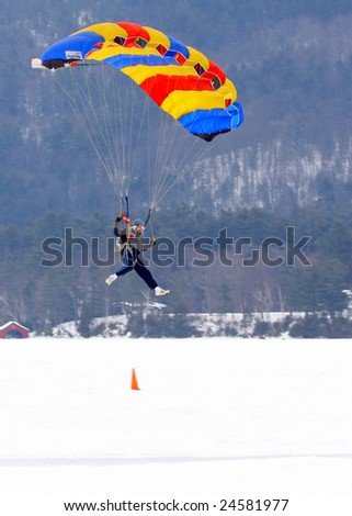 LAKE GEORGE, NY - February 7, 2009: A parachutist coming in for a landing at the start of the February 7 , 2009 Lake George Winter Carnival.