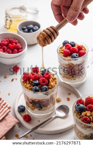 Similar – Image, Stock Photo Blueberries and honey on dark background, top view