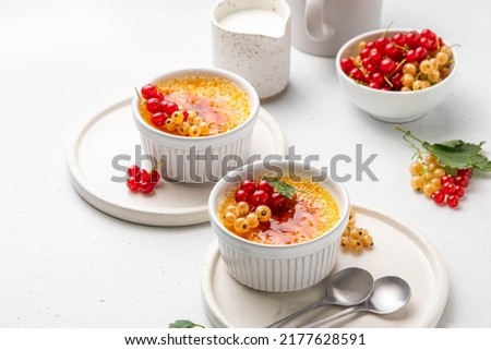 Similar – Image, Stock Photo Creme brulee with caramel crust. Burning sugar on burnt cream