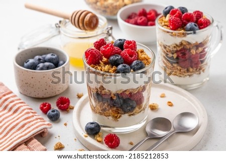Similar – Image, Stock Photo A muesli with yoghurt and fresh fruit in a preserving jar on the breakfast table
