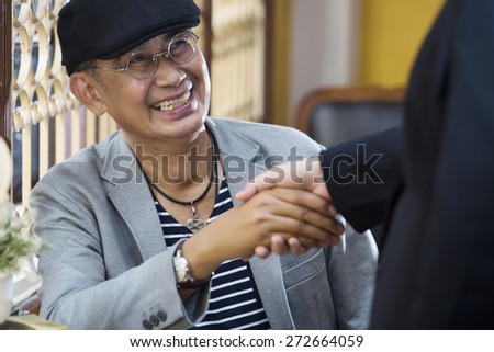 Welcome on board! Man shaking someone\'s hand and smiling