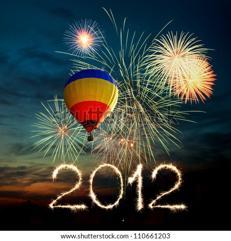 New year 2012. bright colorful fireworks and hot air-balloon of various colors in the night sky at sunset