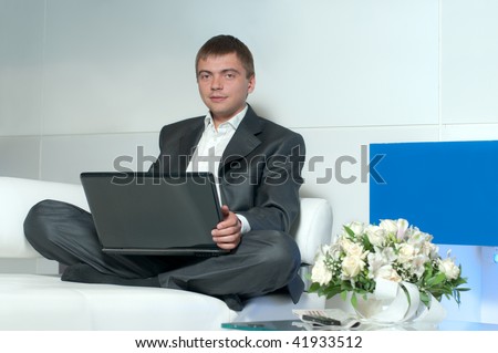 Young businessman relaxing and working at the same time, the work is not a burden