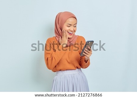 Similar – Image, Stock Photo Positive Muslim woman using smartphone on embankment