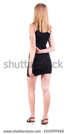 back view of standing beautiful blonde business woman . Young girl in black dress .  Rear view people collection.  backside view of person.  Isolated over white background.