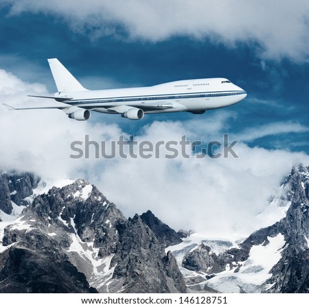plane flying over the snow-capped mountains. passenger airplane in the clouds. travel by air transport. flying to the top of the airliner. nobody
