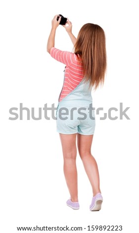 Back view of woman photographing. girl photographer in shorts. Rear view people collection.  backside view of person.  Isolated over white background.