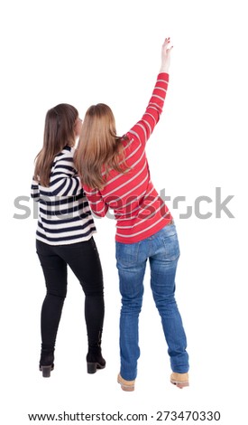 Two long haired friendly women pointing .  backside view of person. Isolated over white background. Rear view people collection.