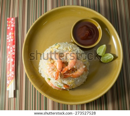 Food and Cuisine, Top View of Oriental Food Shrimp Fried Rice on A Plate Served with Tomato Sauce and Lime Slice.
