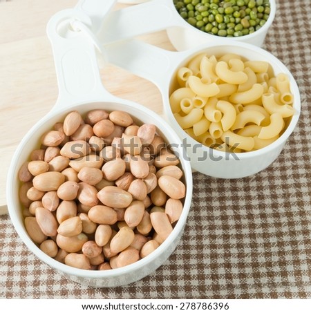 Carbohydrate Foods, Raw Pasta, Rice, Peanuts and Mung Beans in Plastic Measuring Cups.