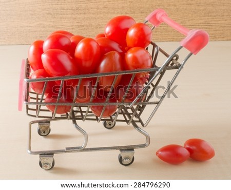 Vegetable, Small Shopping Cart Full with Red Grape Tomatoes or Cherry Tomatoes.
