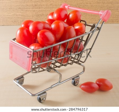 Vegetable, Mini Shopping Cart Full with Fresh Ripe Red Grape Tomatoes or Cherry Tomatoes.