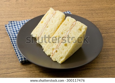 Snack and Dessert, Vanilla Chiffon Cake Made With Butter, Eggs, Sugar, Flour, Baking Powder and Flavorings on A Black Dish.