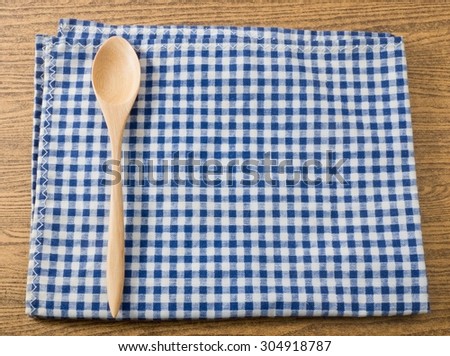 Kitchen Wood Utensil Wooden Spoon on A Blue and White Checked Towel.