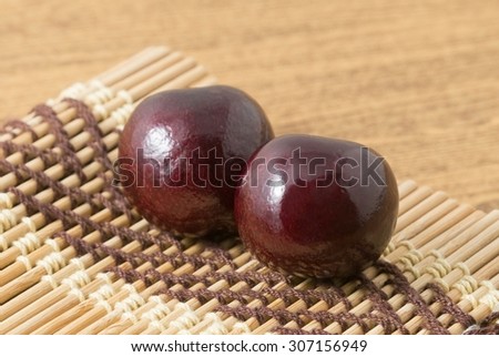 Fresh Fruits, Two Ripe and Sweet Red Plums on A Wooden Mat Plate, Very Good Source of Vitamin C.