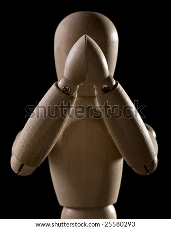 Wood Posing Figure Holding Hands Together In Front of its Face Symmetrically