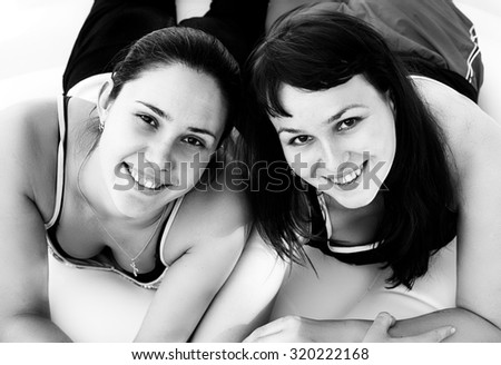 Black and white photo of two happy smiling young girls high contrast