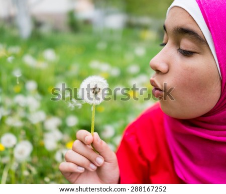 Young Muslim girl in beautiful nature