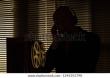 Special agent intelligence officer listens to conversations and records on a reel to reel tape recorder 4 Zdjęcia stock © 