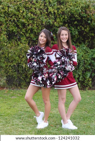 Two Very Cute Teen Aged Cheerleaders Posing Outdoors On A Green Lawn ...