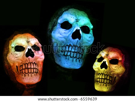 Three illuminated halloween skulls against a black background