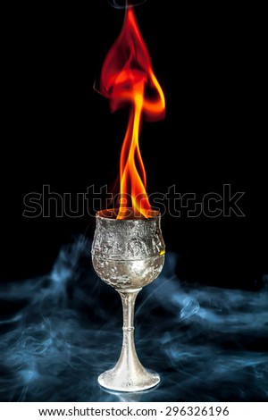 Wine goblet with Fire flames with smoke on black background