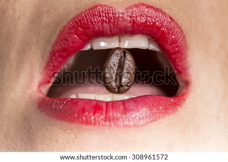 coffee bean between teeth with red lips