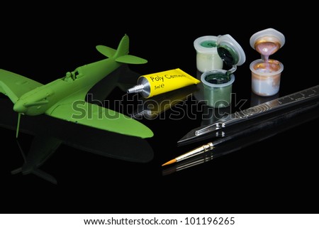 Model fighter plane and model making equipment of acrylic paints, poly cement glue, craft knife and paint brush