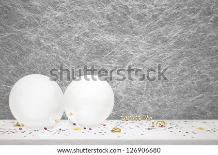 White party balloons, party decorations and confetti on a white table cloth