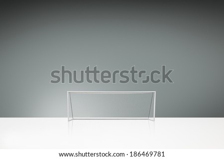 football concept showing empty football goal posts with goal net and space for text