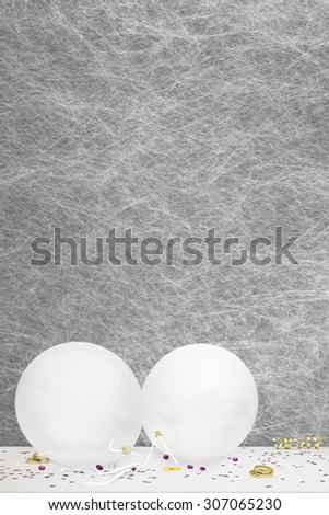 White party balloons, party decorations and confetti on a white table cloth