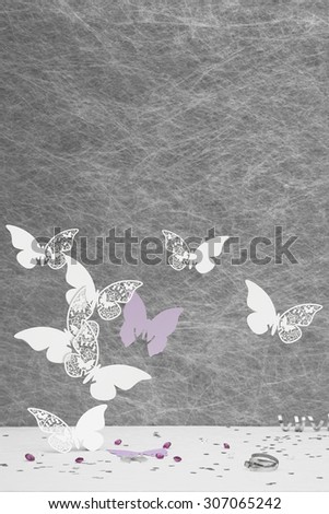 Wedding Place Card butterfly\'s on a White tablecloth with ribbons,bows,silver heart confetti and diamond table decorations