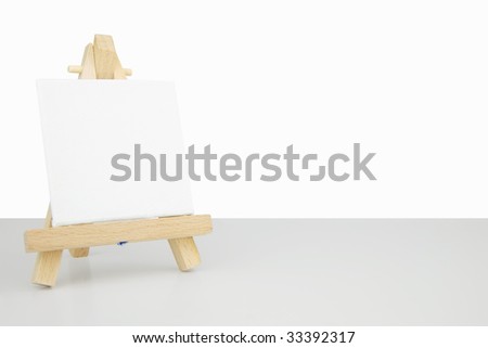 tabletop mini easel with a blank white canvas frame. clipping path saved around easel and canvas for cut out