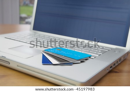 A Group off credit cards and bank cards on a Mobile Computer laptop keyboard