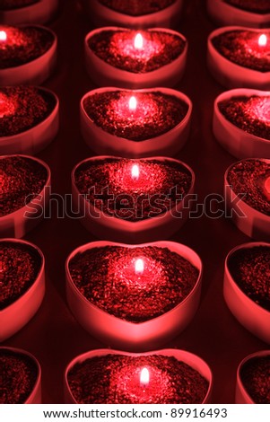 Heart shape candle holders with lighted candles inside