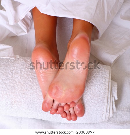 Well-groomed heels of female feet after processing of a skin by oil on a white towel, please see some of my other parts of a body images: