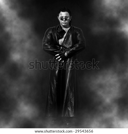 Man in black glasses and a raincoat