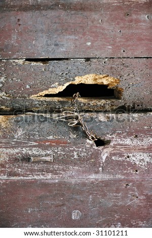 Background from old half-rotten ship boards, are fastened among themselves by a rusty chain