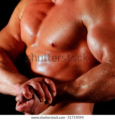 man the body builder shows a biceps and chest muscles