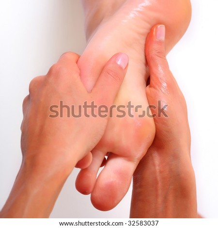 Massage and leaving of the female feet bared by a foot, isolated on a white background, please see some of my other parts of a body images