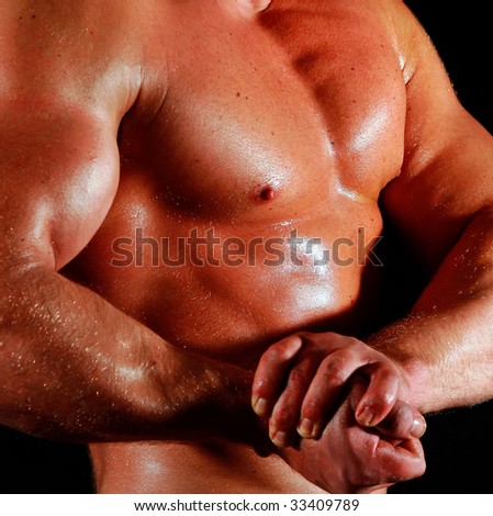 man the body builder shows a biceps and chest muscles