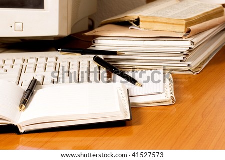 Office equipment on desk with pencils and documents