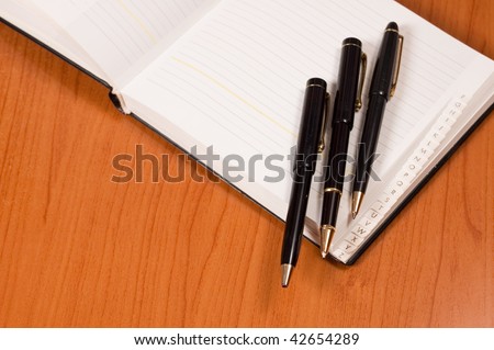 Opened address books with pens