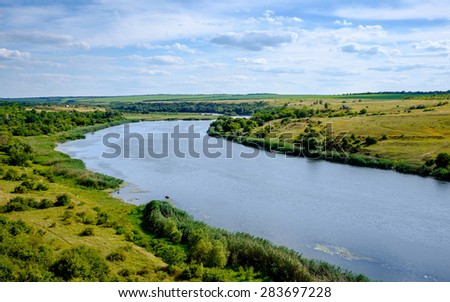River and the field landscape on a sunny summer day. Fantastic landscape. Southern Bug, Ukraine, Europe.