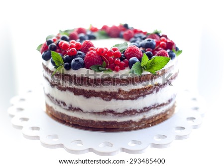 Nude cake with fruits on a white stand