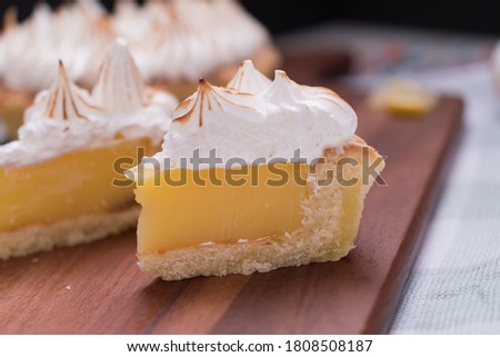 Lemon Pie portions meringue toasted on wooden board on kitchen rag Foto d'archivio © 