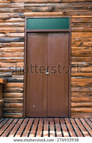 the teak wood wall with mosaic glass above at the teak wood house