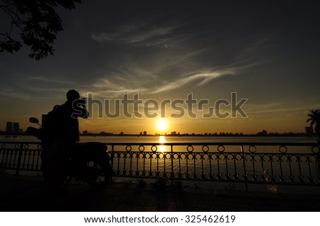 Photographer take photos of sunset West lake.