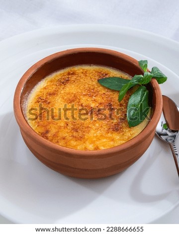 Similar – Image, Stock Photo Creme brulee with caramel crust. Burning sugar on burnt cream